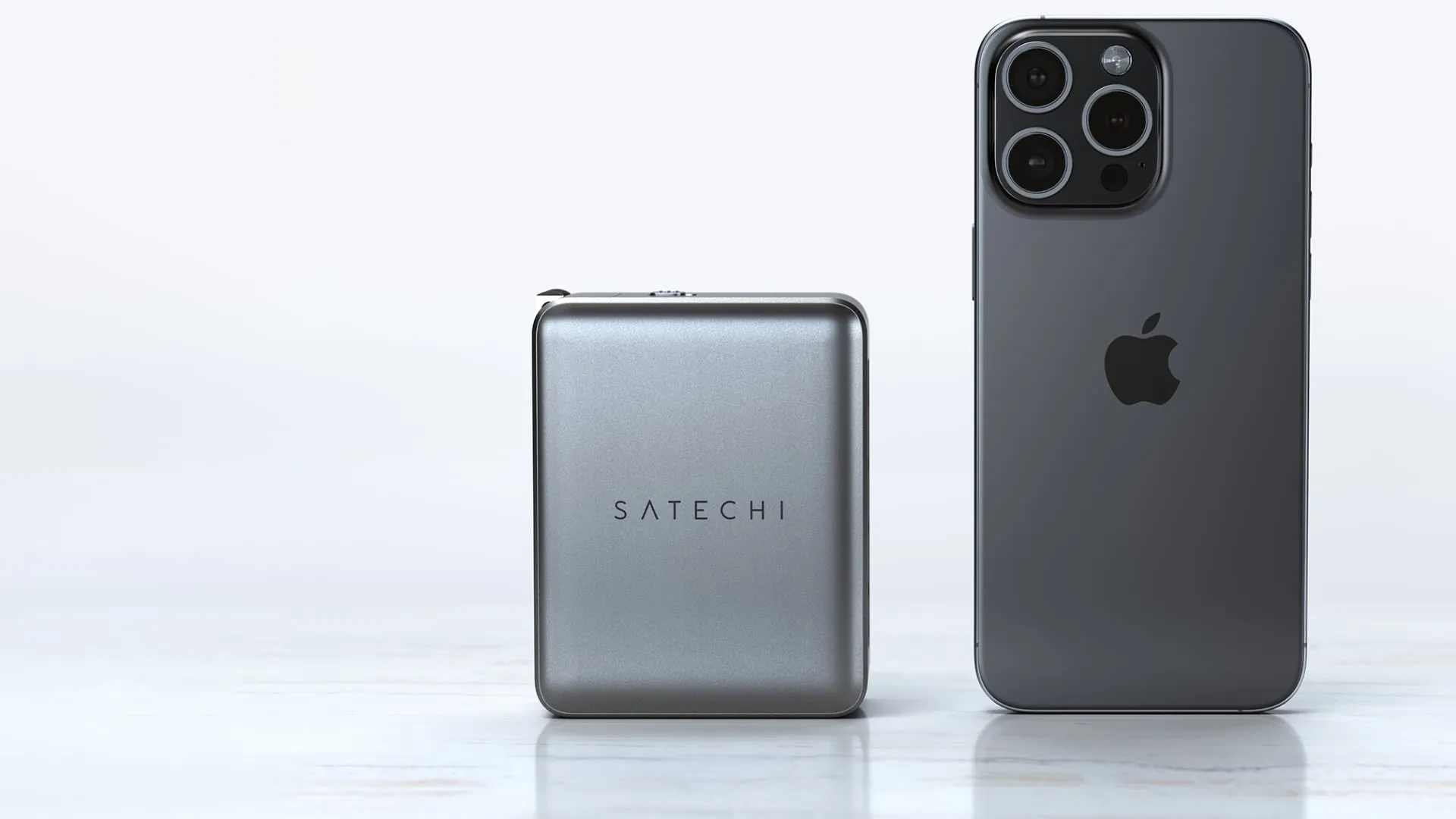 Le chargeur GaN 145 W de Satechi à côté de l'iPhone 15 Pro