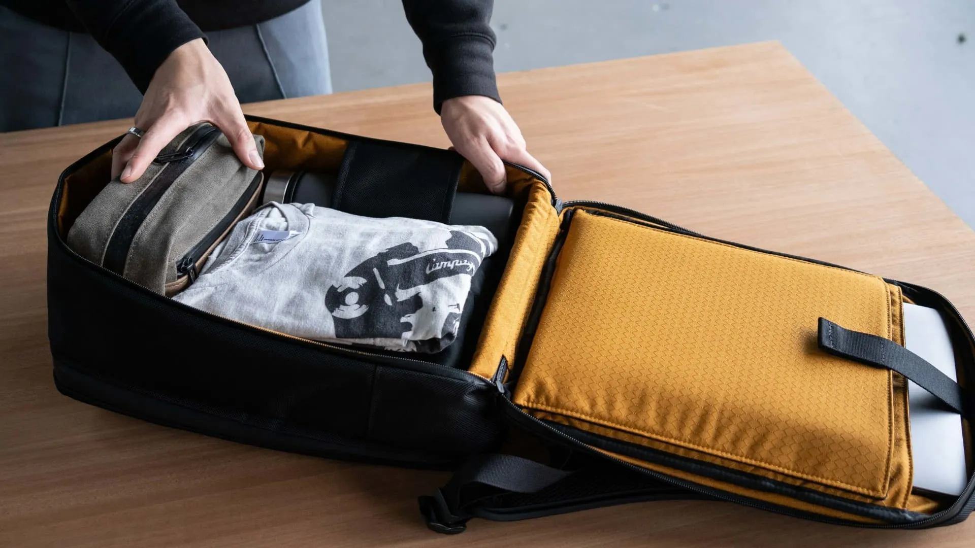 Man packing things in WaterField Designs Tech Folio Backpack Man packing things in WaterField Designs Tech Folio Backpack